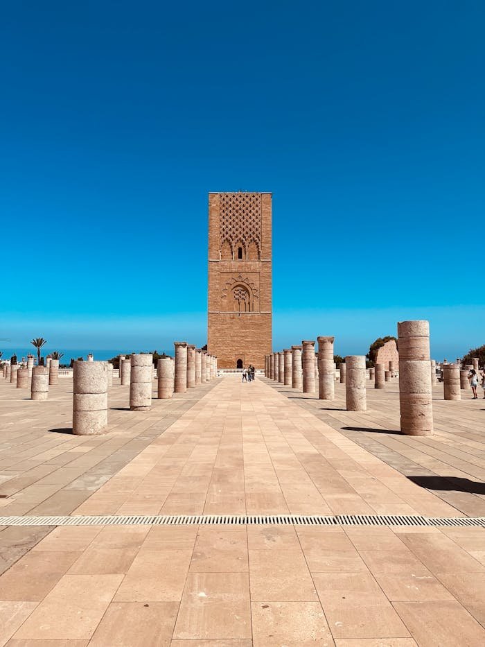 Scenic view of Hassan Tower surrounded by columns in Rabat, Morocco under a clear blue sky.