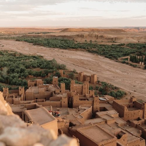 Stunning aerial shot of Ouarzazate's ancient Kasbah in Morocco's arid landscape.
