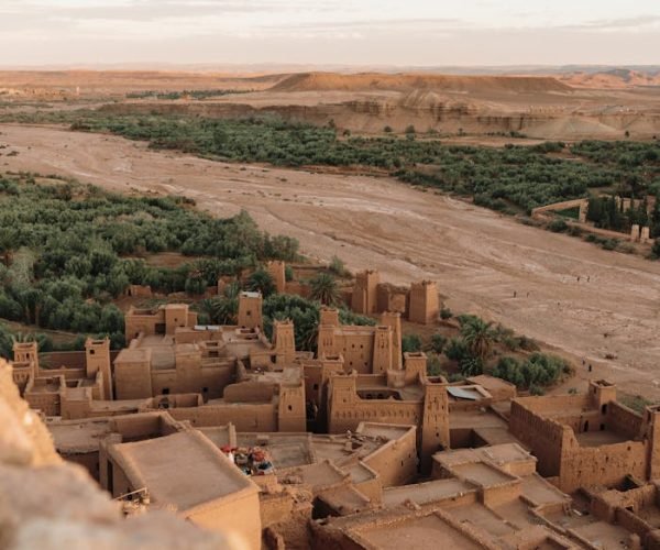 Stunning aerial shot of Ouarzazate's ancient Kasbah in Morocco's arid landscape.