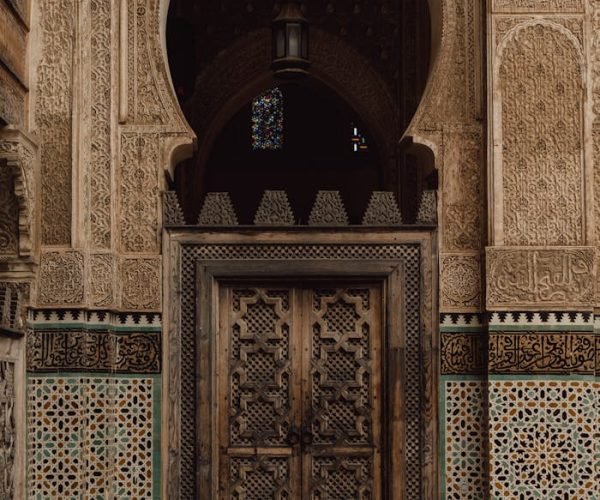 Beautiful Moroccan door with traditional Islamic patterns and mosaic tiles in Fes, Morocco.
