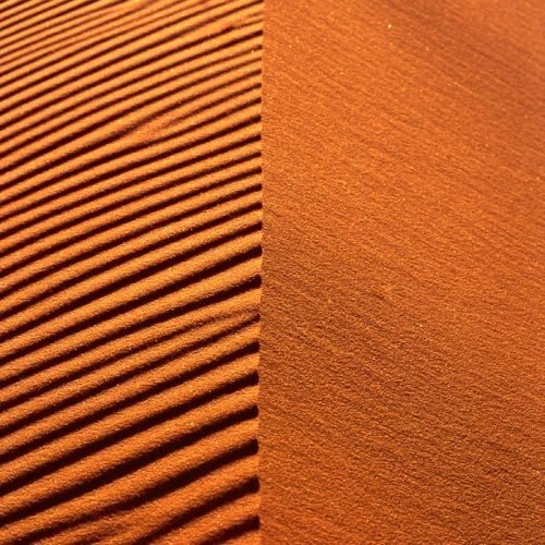 Close-up of rippled sand dunes in the Merzouga Desert showcasing natural patterns.