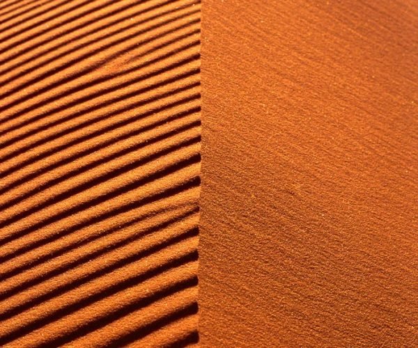 Close-up of rippled sand dunes in the Merzouga Desert showcasing natural patterns.